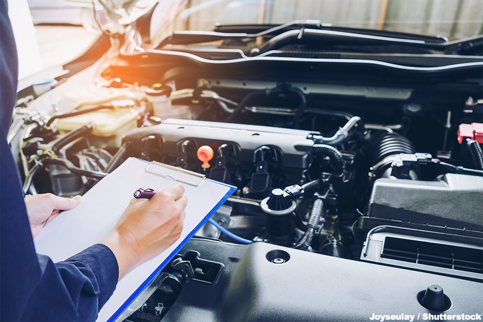 Inspecting an Car with a clipboard